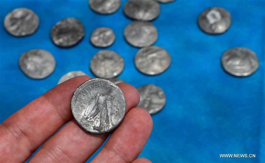 Israeli archeologists said on Tuesday they have unearthed a 'rare' trove of silver coins that a Jewish farmer stashed outside his home west of Jerusalem some 2,140 years ago.