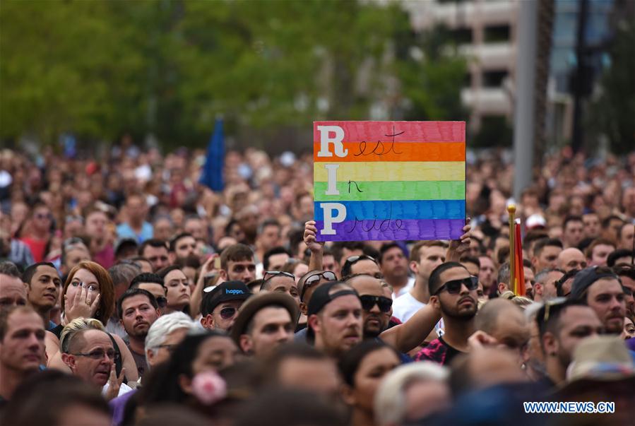 People mourn the victims of the mass shooting during a memorial service in Orlando, the United States, on June 13, 2016. 
