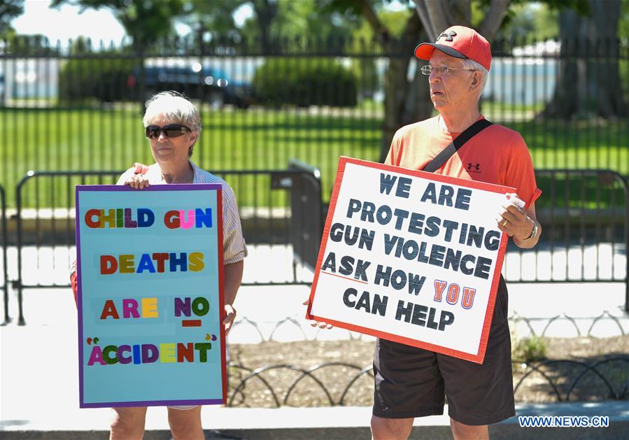 People attend a rally calling for legislation on gun violence prevention and gun control outside the White House, in Washington D.C., capital of the United States, June 13, 2016.