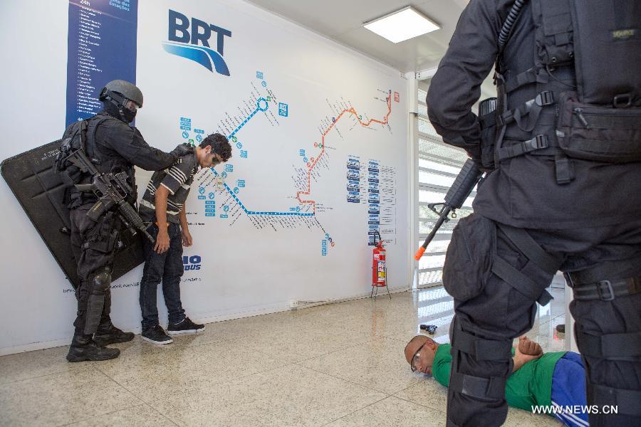 Police officers take simulated terrorists into custody during an anti-terrorism rehearsal at the 'Golfe Olimpico' BRT station in Rio de Janeiro, Brazil, Feb. 11, 2015. 