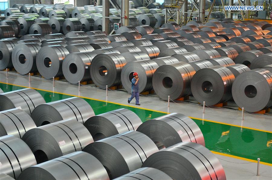 A worker inspects the warehouse of rolled steel coils at Handan Iron and Steel Group Co. Ltd in Handan, north China's Hebei Province, June 23, 2016. 