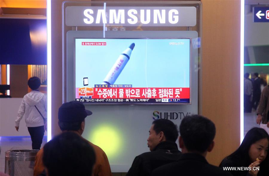 People watch a screen displaying news of the test-firing of a submarine-launched ballistic missile (SLBM) by the Democratic People's Republic of Korea (DPRK), at a railway station in Seoul, capital of South Korea, on April 23, 2016. 