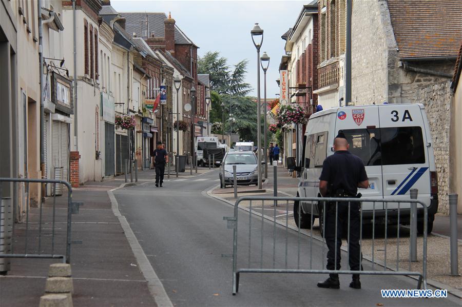 Police stand guard near the church where a priest was killed in Saint-Etienne du Rouvray, France on July 26, 2016.