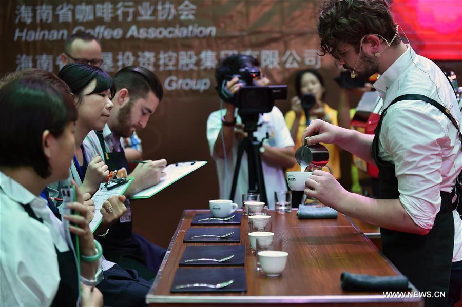 A barista makes fancy coffee during the 5th Fushan Cup International Barista Championship of China in Chengmai, south China's Hainan Province, June 6, 2016