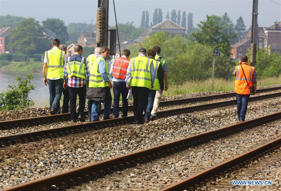 Security personnel work at the site of train crash in the town of Saint-Georges-sur-Meuse in the province of Liege, Belgium, June 6, 2016.