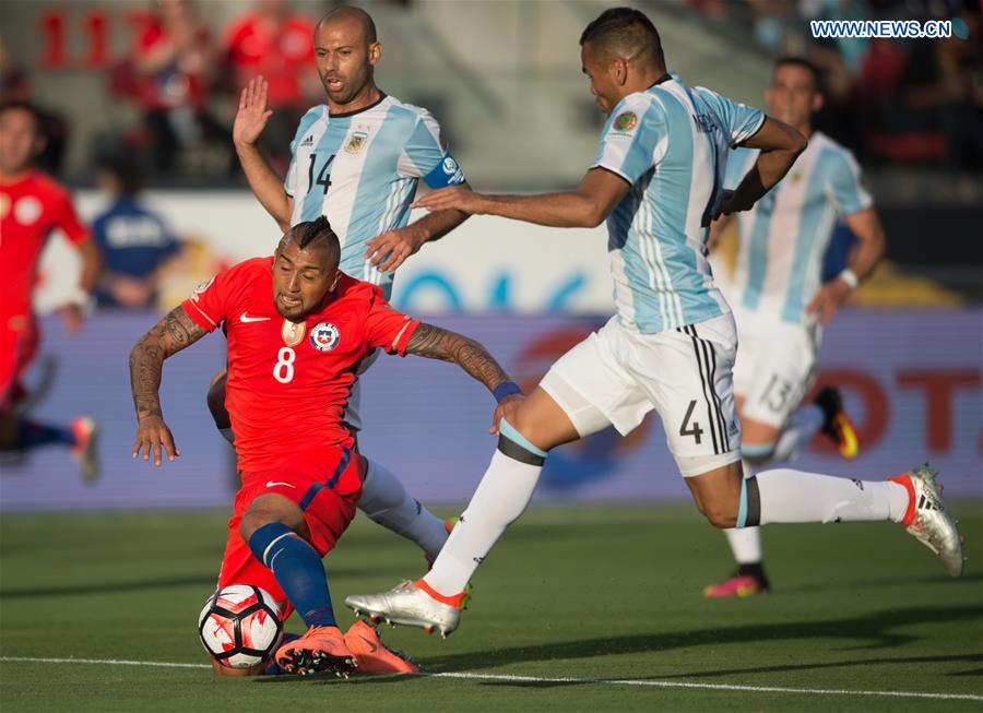 Chile's Arturo Vidal (down) vies for the ball during the Copa America Centenario Group D match between Argentina and Chile at the Levi's Stadium in Santa Clara, California, the United States, June 6, 2016. 
