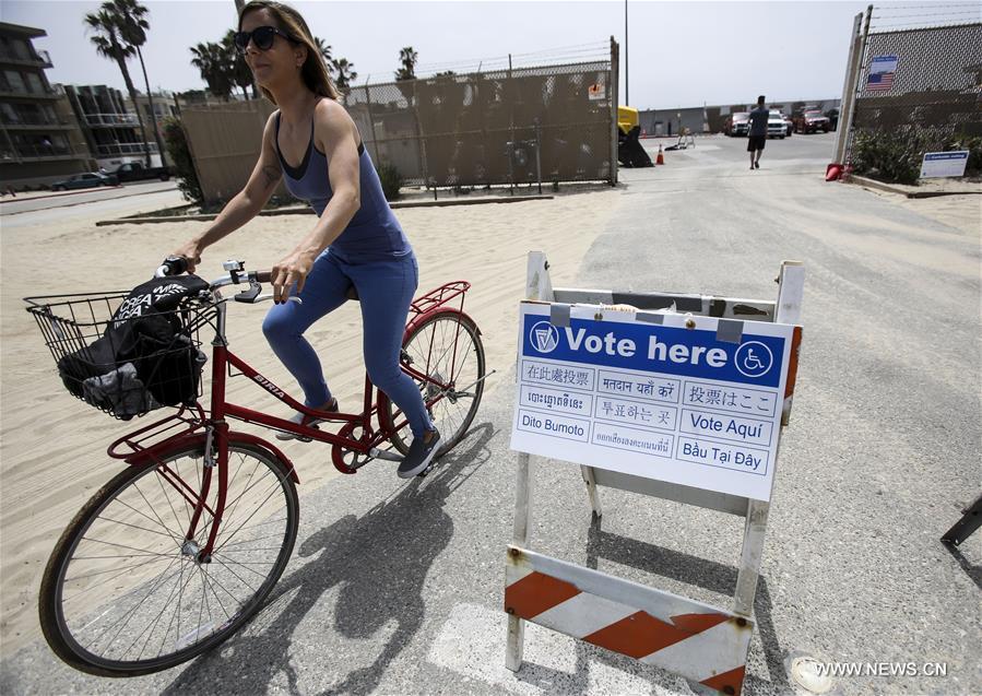 Residents wait in line to cast their votes during the presidential primary election at Santa Monica City Hall in Santa Monica, California, the United States, on June 7, 2016. 
