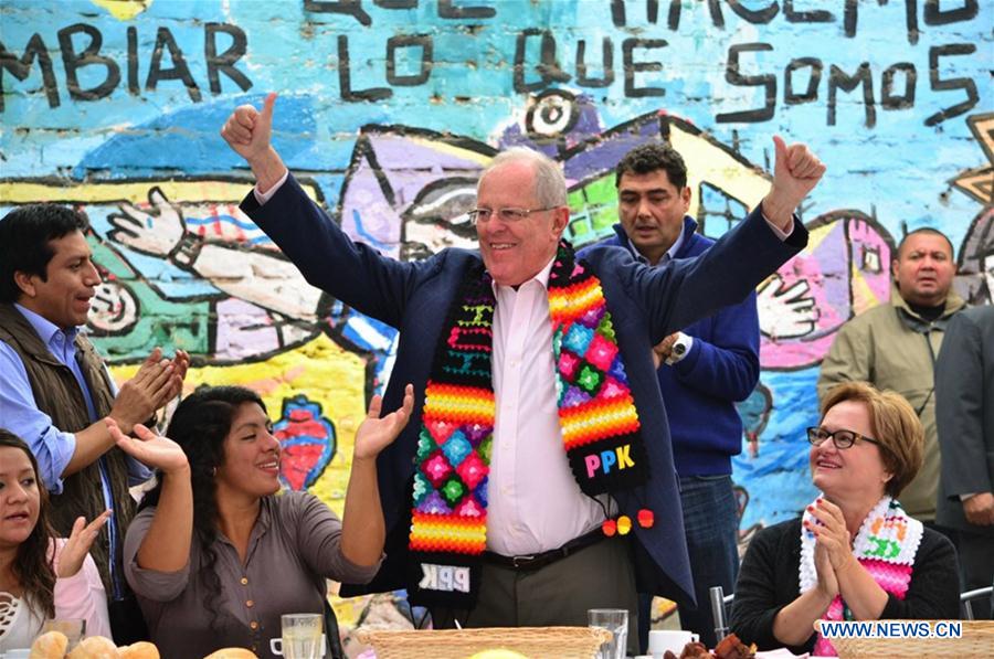 Image taken on June 5, 2016 shows the presidential candidate of the party Peruvians for Change (PPK), Pedro Pablo Kuczynski, greeting after casting his vote in the second round of the presidential elections, in the San Isidro district, in Lima, Peru. 