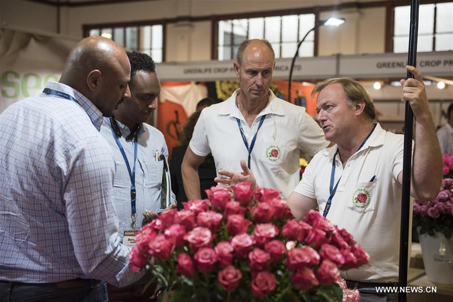 Flower buyers talk with exhibitors during the fifth edition of International Floriculture Trade Expo in Nairobi, Kenya, on June 9, 2016.