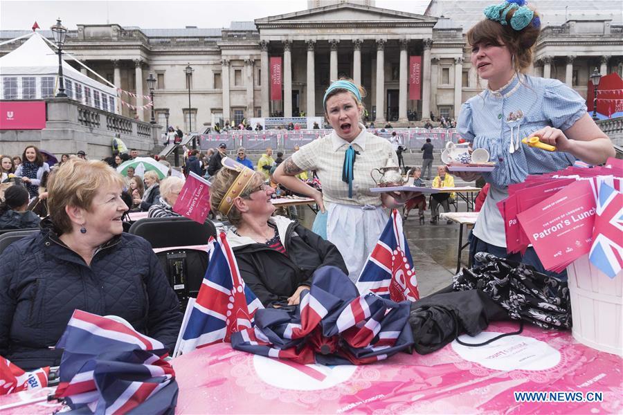 People celebrate Queen Elizabeth II's official 90th birthday at Trafalgar Square in London, June 12, 2016.