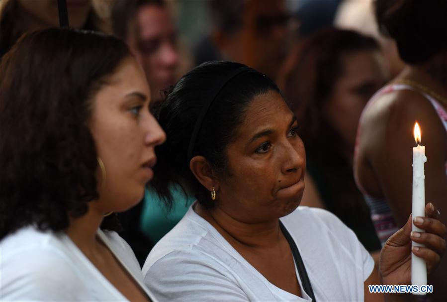 People mourn the victims of the mass shooting during a vigil at a park in Orlando, the United States, on June 12, 2016.