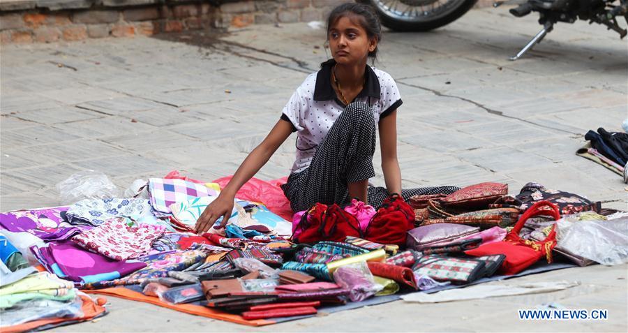 A girl sells goods on the World Day Against Child Labour in Kathmandu, Nepal, June 12, 2016. 