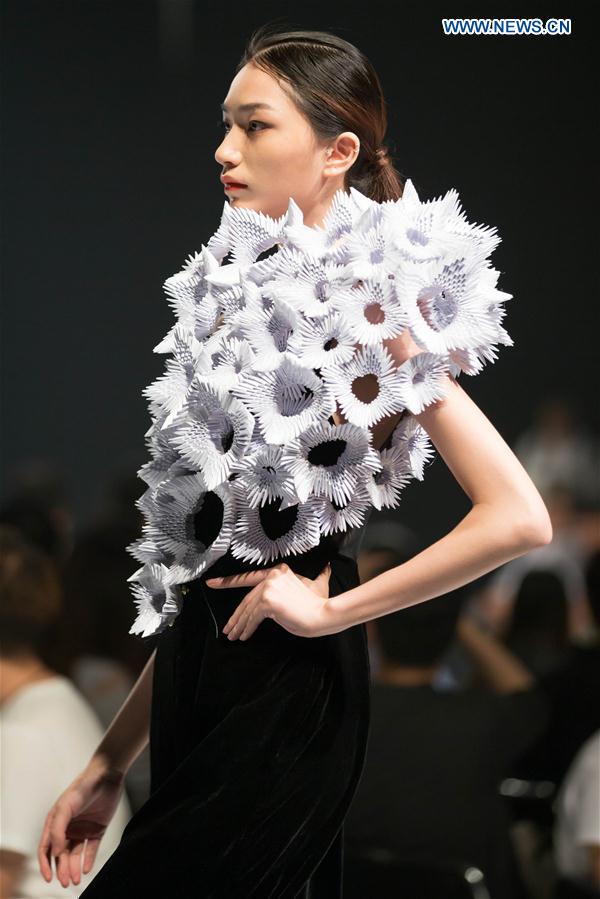 A model presents a creation designed by graduates of Beijing Institute of Fashion Technology in Beijing, capital of China, June 14, 2016.