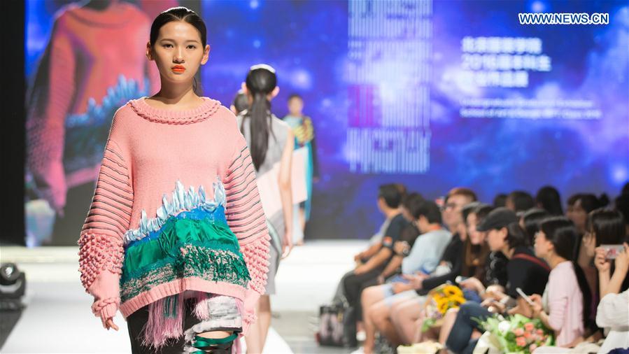  model presents a creation designed by graduates of Beijing Institute of Fashion Technology in Beijing, capital of China, June 14, 2016. 