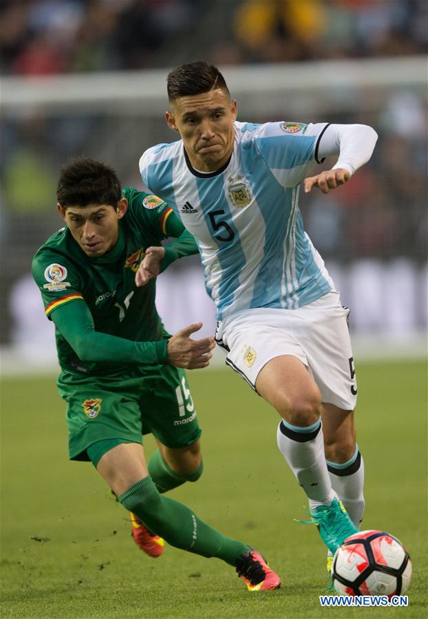 Matias Kranevitter (R) of Argentina vies for the ball during a Copa America Group D soccer match against Bolivia in Seattle, the United States, on June 14, 2016. 