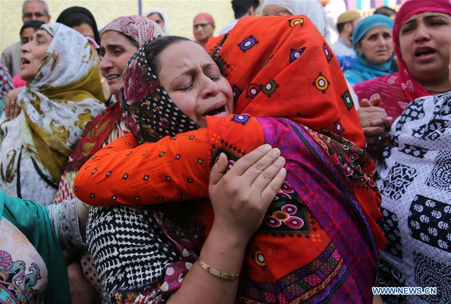 People cry during the funeral of Tanvir Ahmad Sheikh in Srinagar, summer capital of Indian-controlled Kashmir, on June 15, 2016. 
