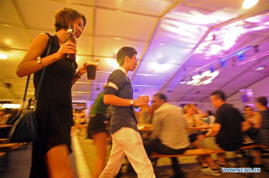 Drinkers enjoy beer at the Beerfest Asia held at Singapore Flyer F1 track, June 16, 2016.