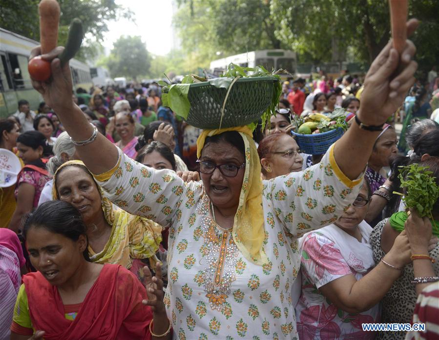 Women attend a demonstration against hiking price of essential commodities near the headquarters of ruling Bharatiya Janata Party (BJP) in New Delhi, India, June 16, 2016. 