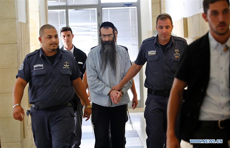 Yishai Schlissel, an orthodox man who is charged with stabbing and murder at the annual gay parade event in Jerusalem surrounded by policemen arrives to the district court to attend a hearing in Jerusalem on June 16, 2016. 