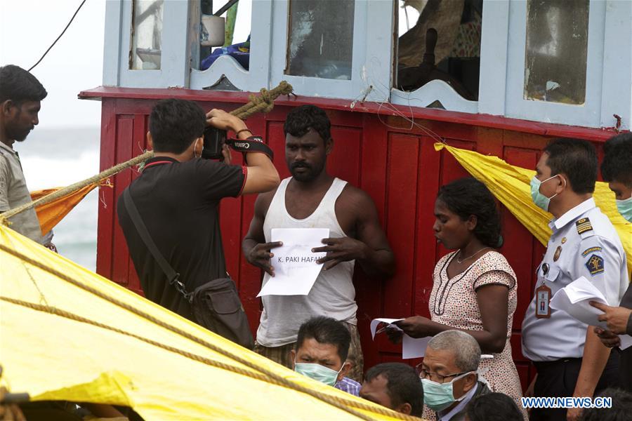 Sri Lankan migrants wait for identification on a migrant boat stranded at Lhoknga Beach, Aceh, Indonesia, June 16, 2016.