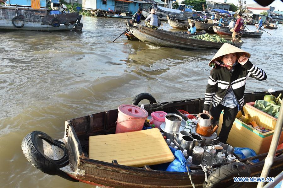 A Vietnamese vendor sells fruits in Can Tho's largest floating market Cai Rang, Vietnam, June 21, 2016