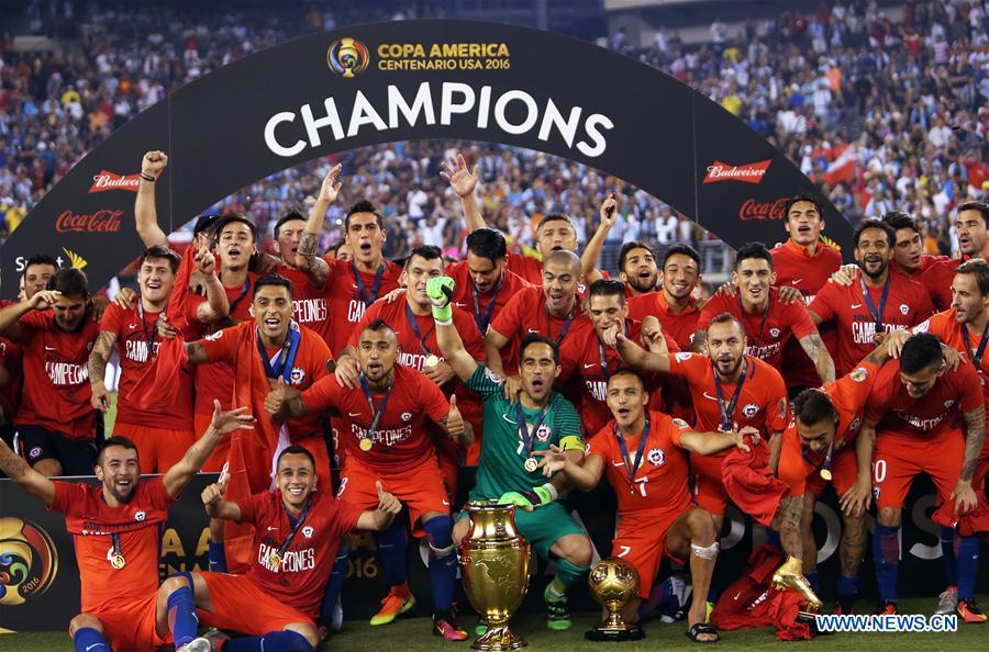Players of Chile celebrate with the trophy after winning the final of 2016 Copa America Centenario soccer tournament at the Metlife Stadium in New Jersey, the United States on June 26, 2016