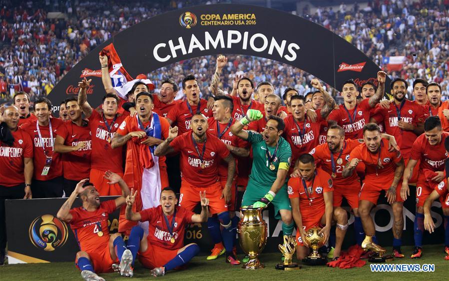 Players of Chile celebrate with the trophy after winning the final of 2016 Copa America Centenario soccer tournament at the Metlife Stadium in New Jersey, the United States on June 26, 2016