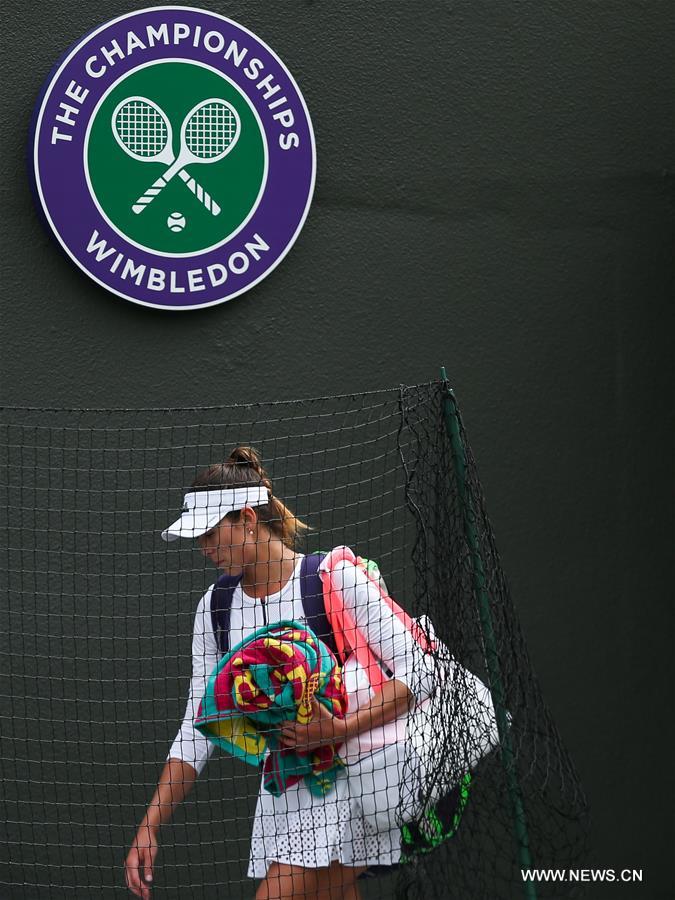 Garbine Muguruza of Spain leaves the court after the women's singles second round match with Jana Cepelova of Slovakia on Day 4 at the Wimbledon Championships 2016 in London, Britain, on June 30, 2016. 