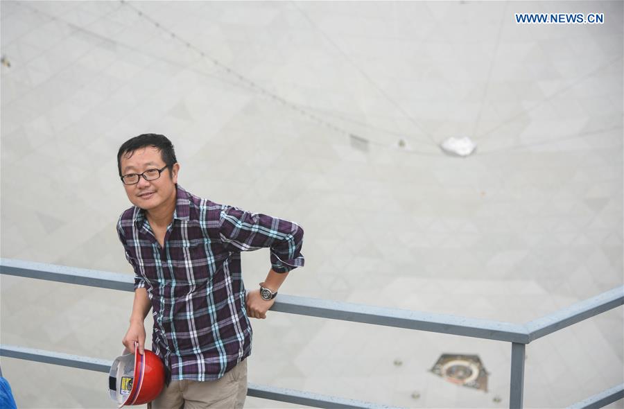 Chinese prominent science fiction writer Liu Cixin is seen at the site to witness the installation completion on the Five-hundred-meter Aperture Spherical Telescope (FAST) in Pingtang County, southwest China's Guizhou Province, July 3, 2016. 
