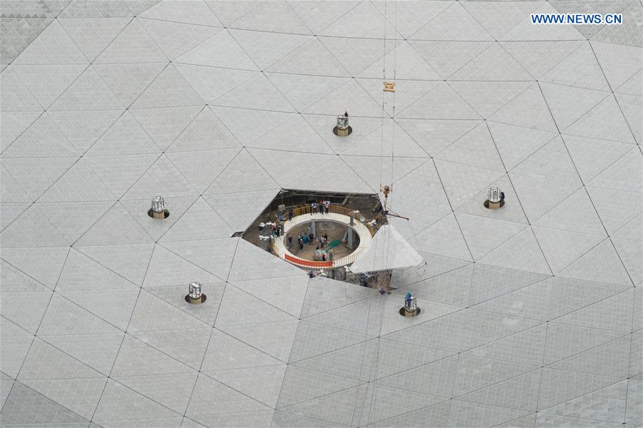 The last triangular panel to the reflector of the Five-hundred-meter Aperture Spherical Telescope (FAST) is being installed in Pingtang County, southwest China's Guizhou Province, July 3, 2016. 