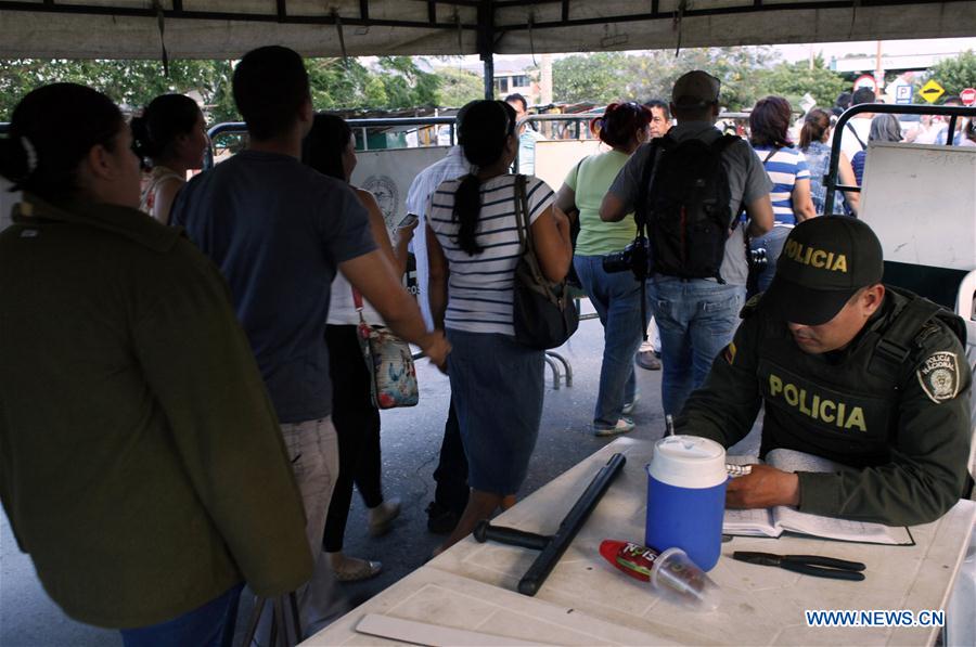 Photo provided by Diario La Opinion shows Venezuelan citizens crossing the border between Venezuela and Colombia to buy food and other products in San Jose de Cucuta, Colombia, on July 10, 2016.