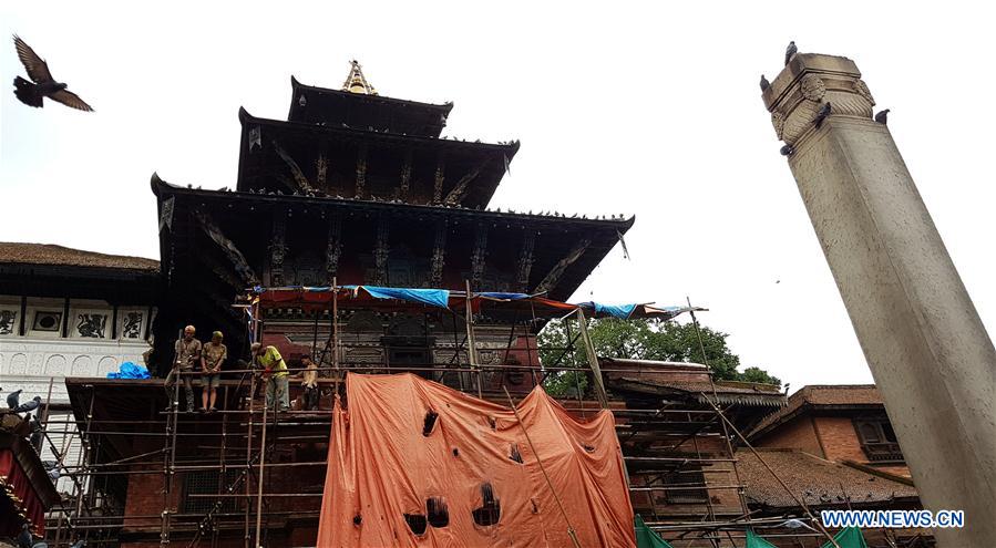 People work at the reconstruction site of a damaged temple at Hanumandhoka Durbar Square, a UNESCO heritage site in Kathmandu, Nepal, July 11, 2016. 