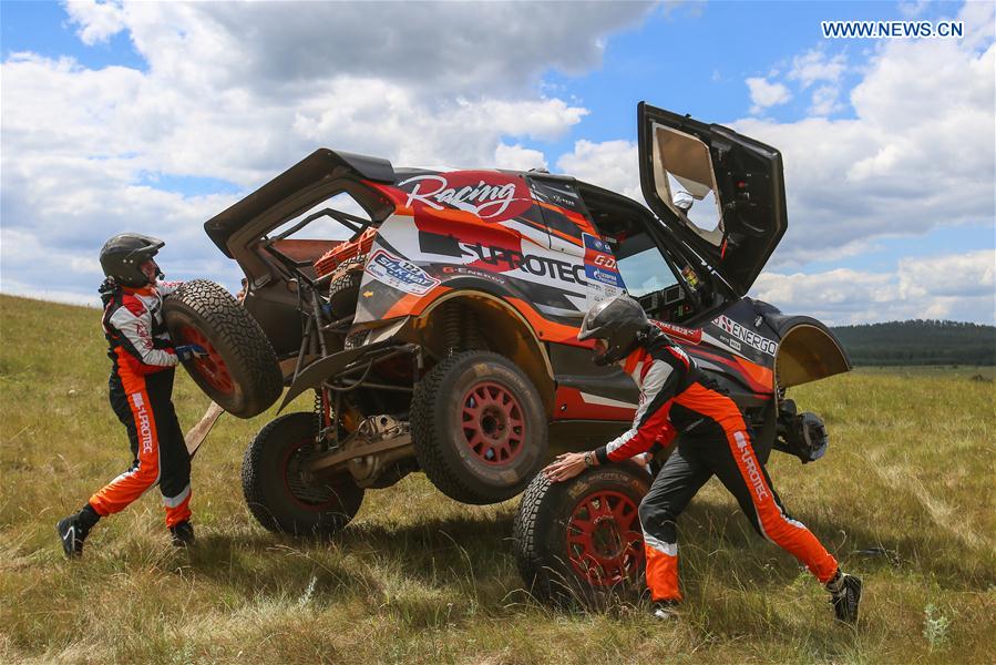 Andrey Rudskoy (L) and Evgeny Zagorodniuk of Suprotec Racing change the wheel during the third stage of the Moscow-Beijing Silk Road rally 2016 in Ufa, Russia on July 11, 2016.