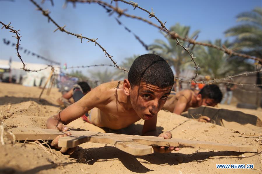 Palestinians take part in a military exercise at a summer camp, organized by Islamic Jihad movement, in the southern Gaza Strip City of Khan Younis, on July 13, 2016. 