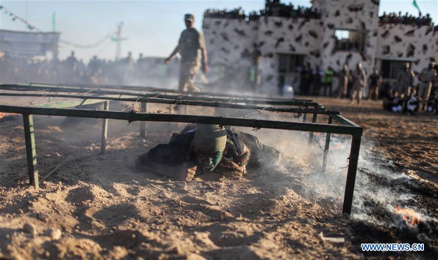 A Palestinian shows his skills during a military graduation ceremony as part of a military-style summer camp organized by Hamas's armed wing in Gaza City, on July 22, 2016. 
