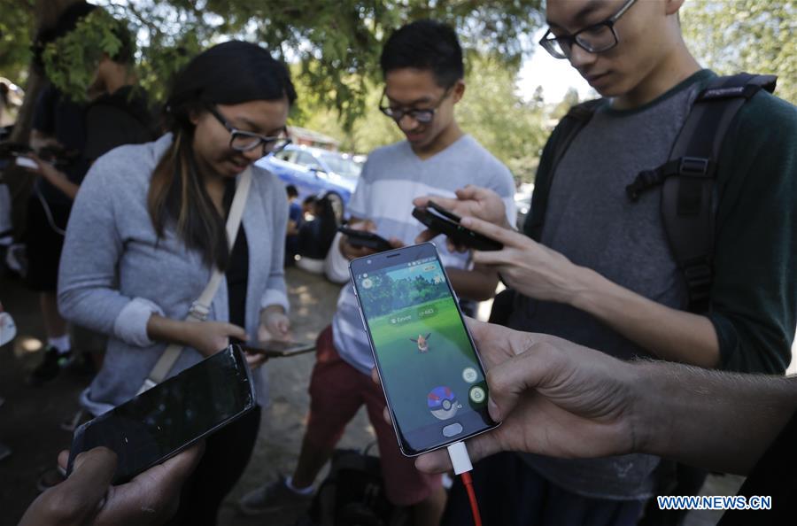 People play 'Pokemon Go' during a gathering at Stanley Park in Vancouver, Canada, July 23, 2016.