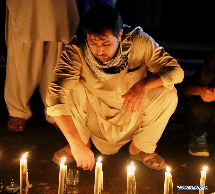 People attend a candlelight vigil to commemorate victims of a suicide attack in Kabul, capital of Afghanistan, July 23, 2016.