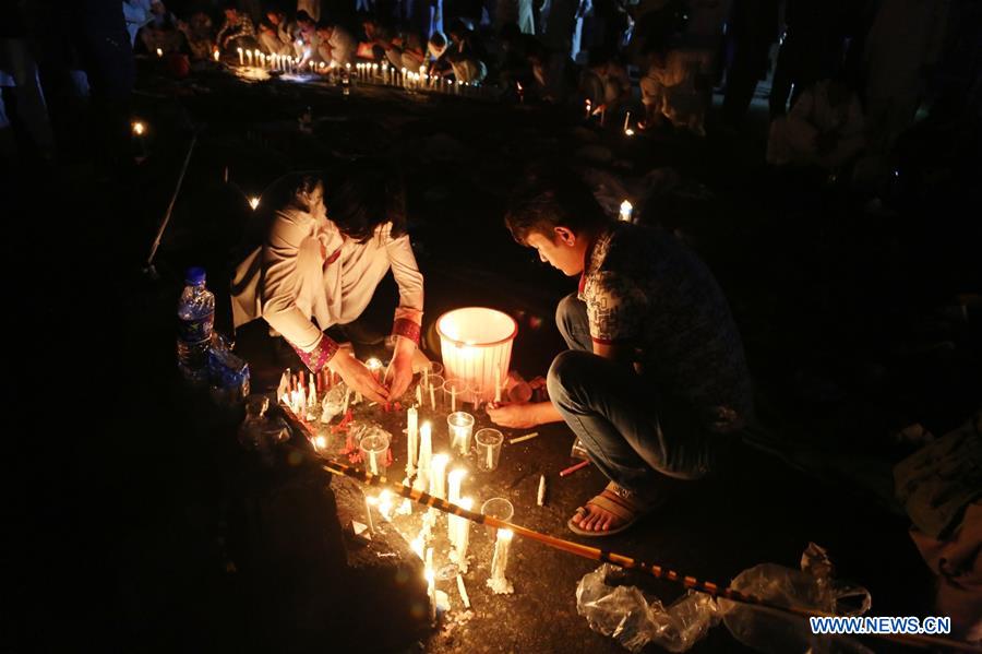 People attend a candlelight vigil to commemorate victims of a suicide attack in Kabul, capital of Afghanistan, July 23, 2016.
