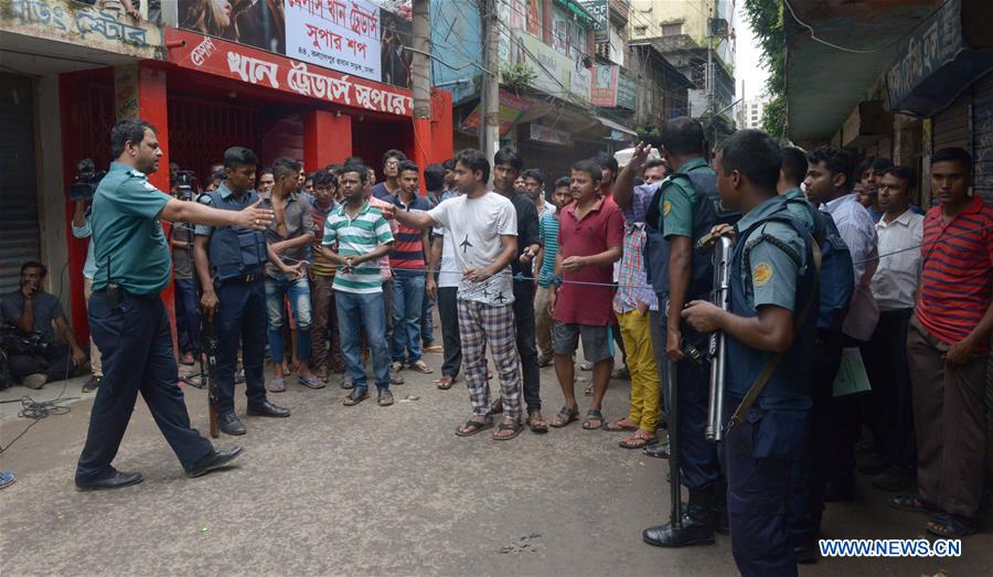 Policemen stand guard at the site where nine suspected militants were killed in Dhaka, Bangladesh, on July 26, 2016. 