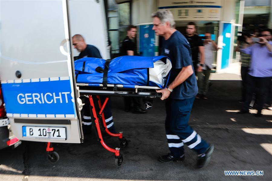Medical personel transport a body at the Benjamin-Franklin Hospital in the southwestern district of Steglitz in Berlin, Germany, July 26, 2016. 