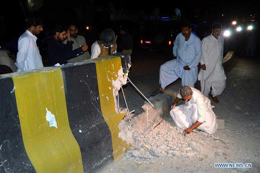 Security officials examine the blast site in southwest Pakistan's Quetta, on July 27, 2016. 