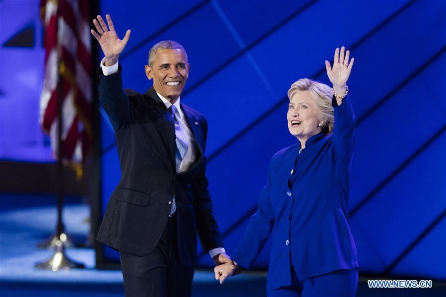 U.S. President Barack Obama (L) hugs U.S. Democratic Presidential Candidate Hillary Clinton on the third day of the 2016 U.S. Democratic National Convention, at Wells Fargo Center in Philadelphia, Pennsylvania, the United States, on July 27, 2016. 