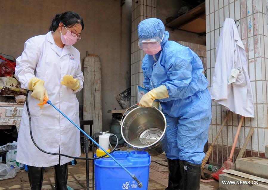 Local health and medical staff started a disinfection operation at temporary shelters relocating people affected by recent torrential rain and flood.