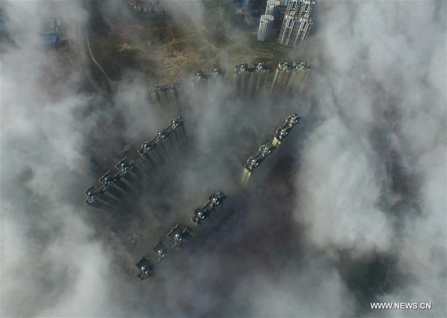 Photo taken on July 30, 2016 shows Qinzhou City enveloped by fog in south China's Guangxi Zhuang Autonomous Region. 