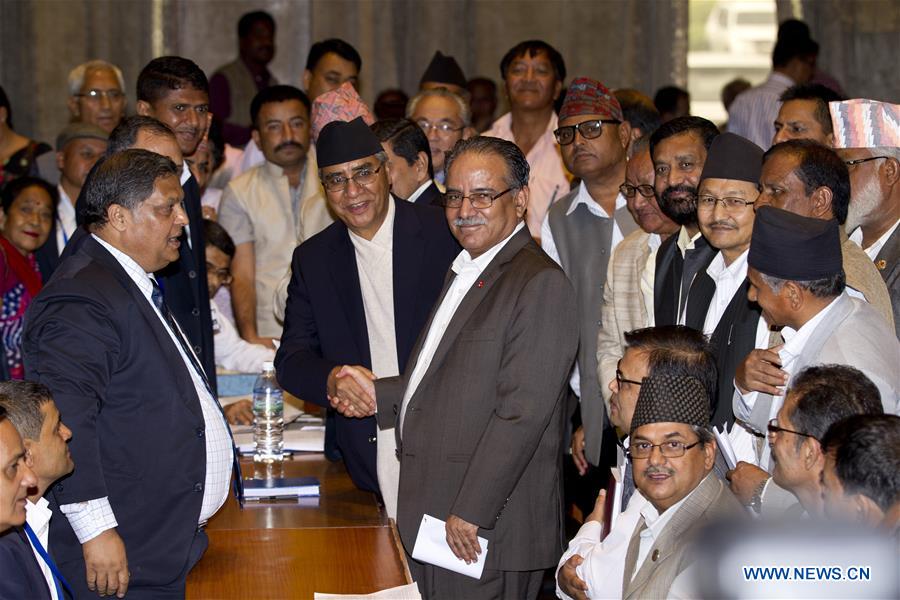 Nepal's Chairman of CPN Maoist-Centre Pushpa Kamal Dahal (C) shakes hands with Nepalese Congress President Sher Bahadur Deuba after registering his candidacy for the post of prime minister in Kathmandu, capital of Nepal, on Aug. 2, 2016.