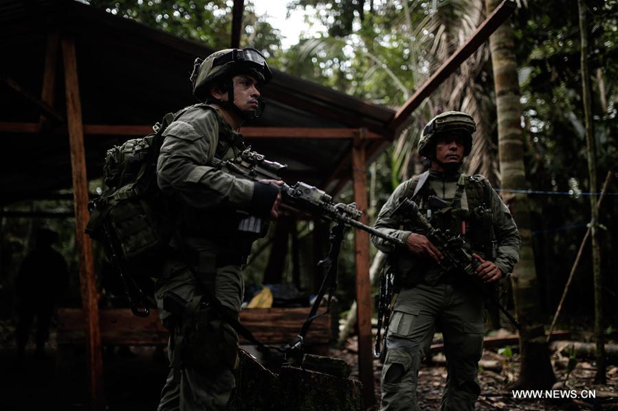 Member of the jungle group of the Counter-narcotics Police stand on guard in a rural zone of Calamar Municipality, Guaviare Department, Colombia, on Aug. 2, 2016.
