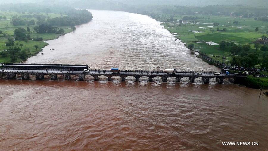 Two bodies have been recovered while over 20 others are feared missing after a British-era bridge collapsed on a highway in the western Indian state of Maharashtra in the wee hours of Wednesday, plunging around a dozen vehicles into the water, officials said. 