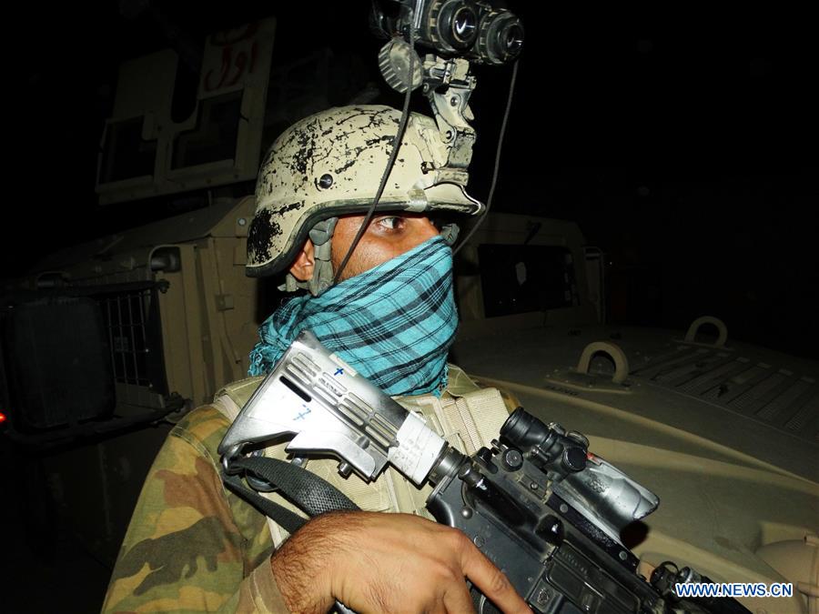 An Afghan special force member takes part in a night military operation against Taliban in Nad Ali district of Helmand province, Afghanistan, Aug. 2, 2016. 