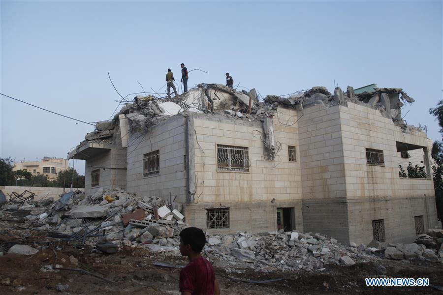 People inspect the family house of Palestinian Mohammad Makhamreh after it was demolished by an Israeli army bulldozer in the West Bank village of Yatta, south of Hebron, on Aug. 4, 2016.