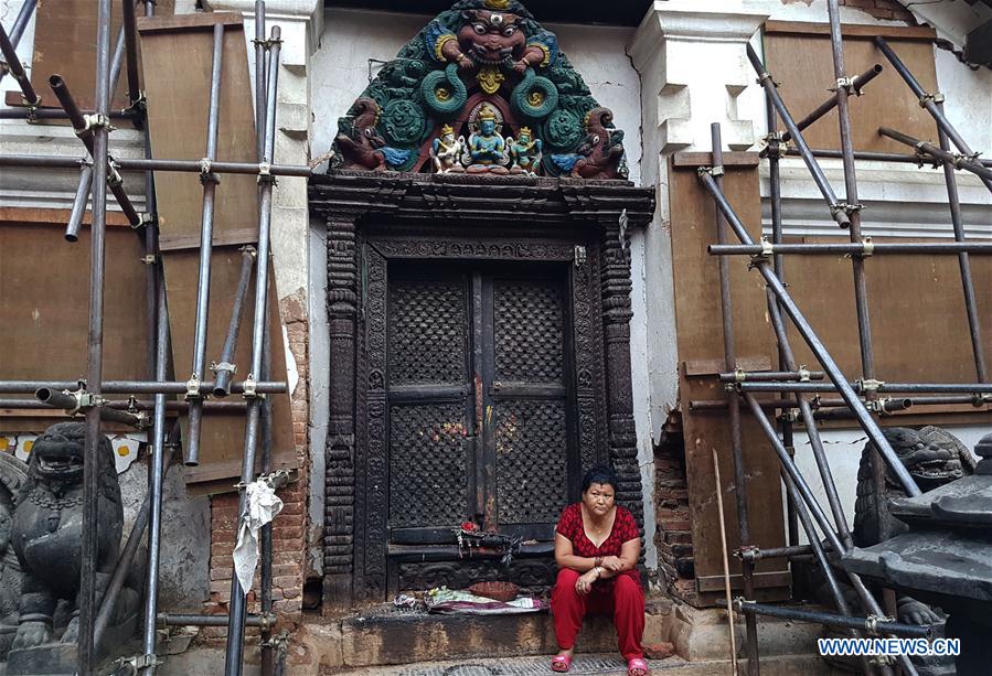 A woman takes a rest at Swayambhunath in Kathmandu, Nepal, Aug. 5, 2016.